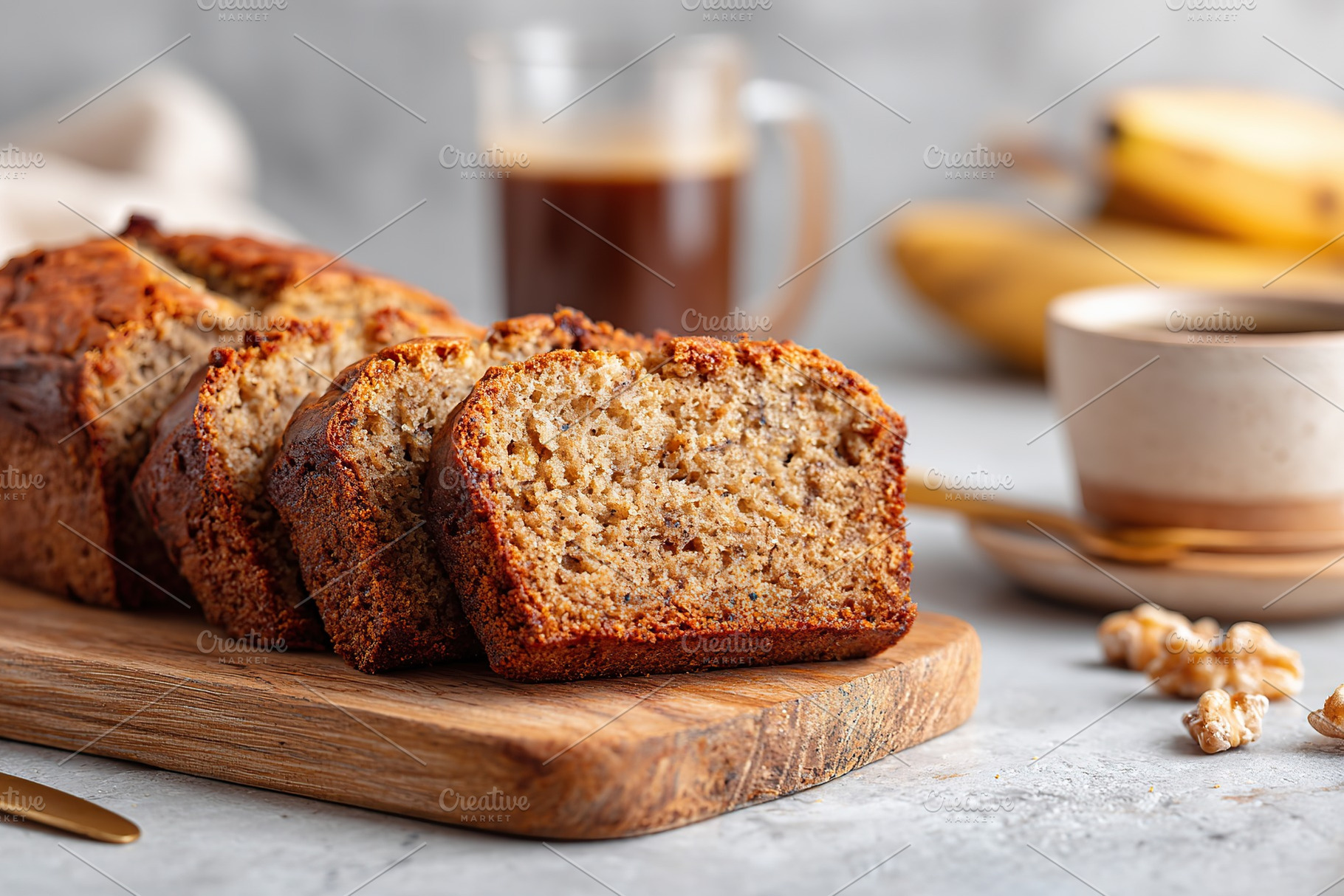Delicious banana bread slices served on a wooden board beside coffee and banana, a Food & Drink Photo by AlyaAnd