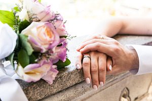 Young married couple holding hands stock photo containing rings and wedding