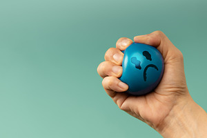 Hand Squeezing a ball used for emotional control and mental heal, a Photo by salmon.black