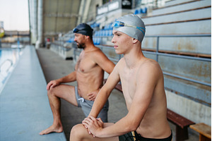 Father and teenage son preparing for, a Sports & Recreation Photo by HalfPoint