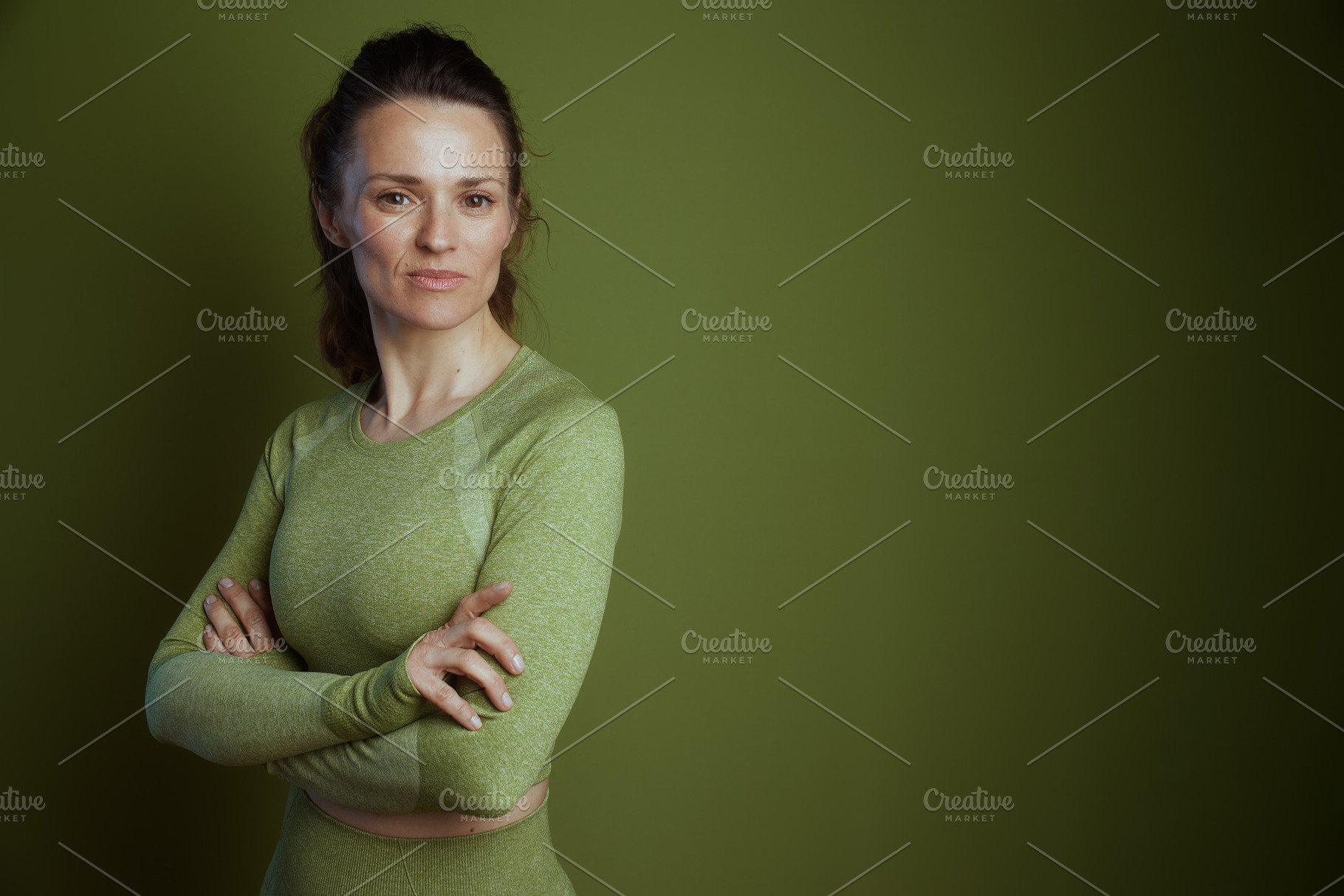 Middle-aged woman in green workout gear, a Person Photo by Alliance Images