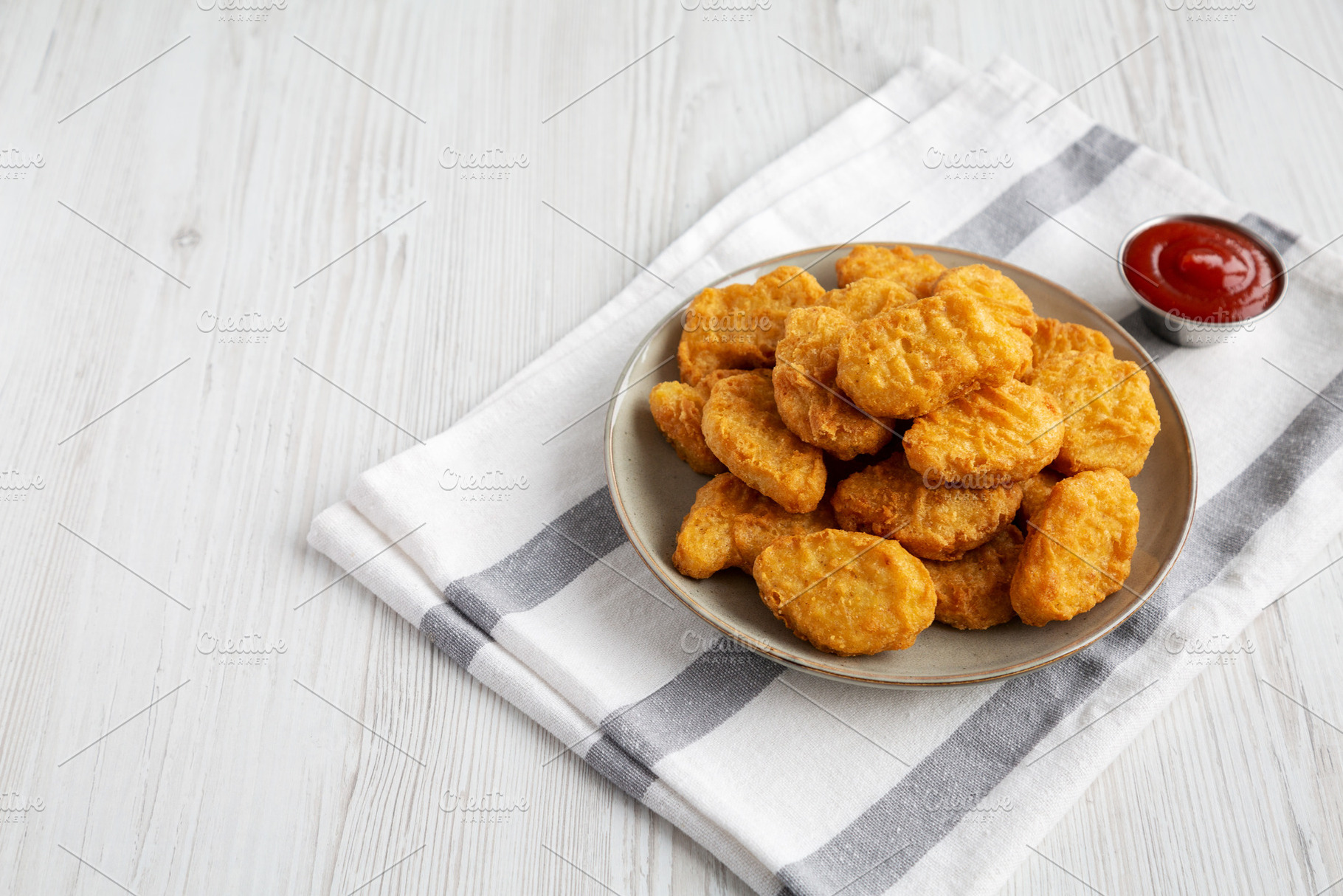 Homemade Chicken Nuggets with Ketchup, side view., a Food & Drink Photo by LiudmylaChuhunova