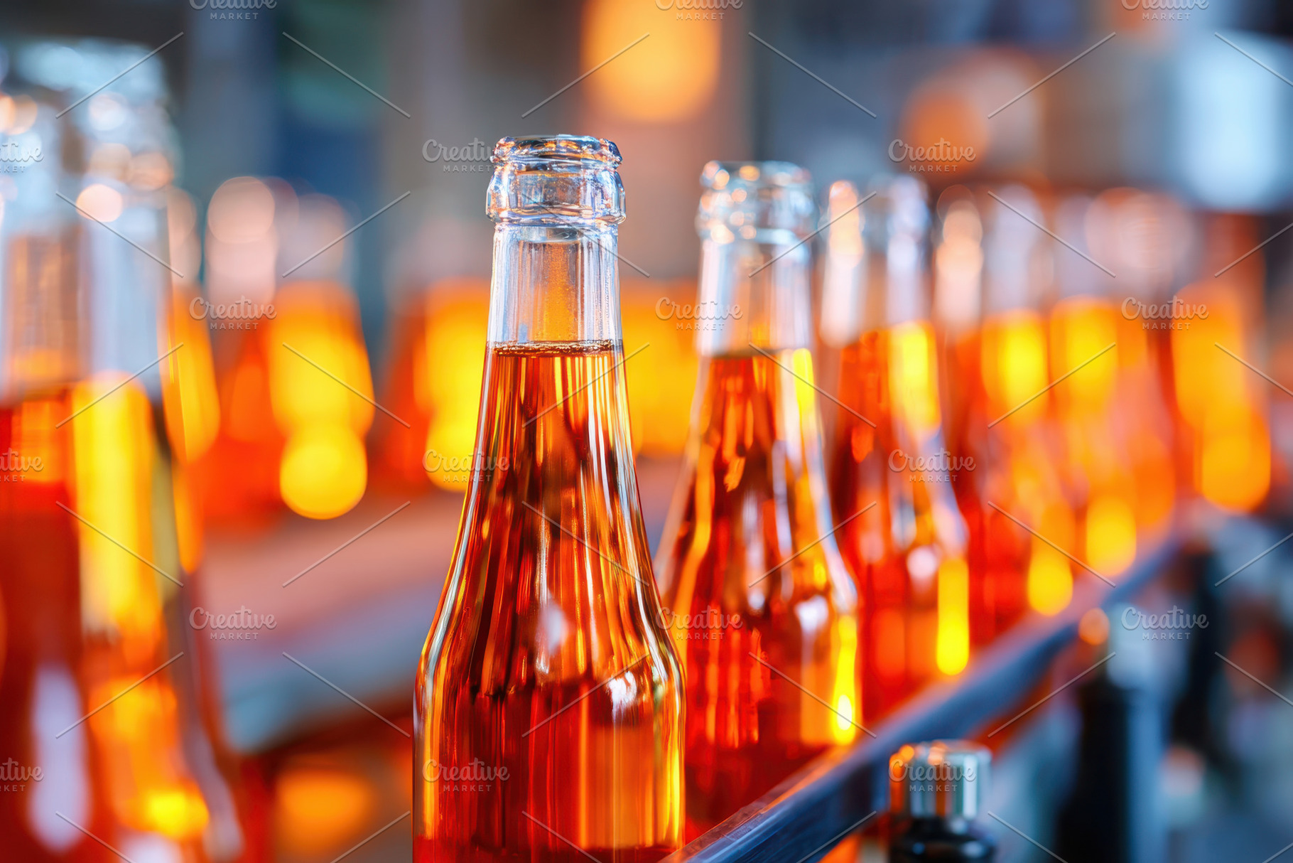 Row of amber bottles in warm light, a Food & Drink Photo by AlyaAnd