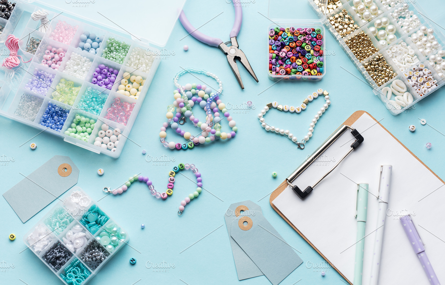 Colorful beads, pliers, clipboard and price tags arranged on blu, an Arts & Entertainment Photo by Olena Rudo