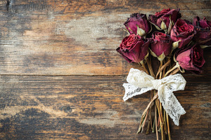 Dried roses tied with lace on wood, a Photo by Beautiful things