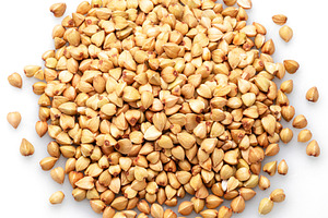 Hulled kernels of buckwheat cereal isolated on white background., a Food & Drink Photo by Volff