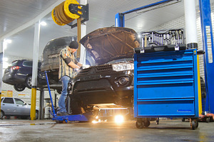 Car service. Mechanic man repairing