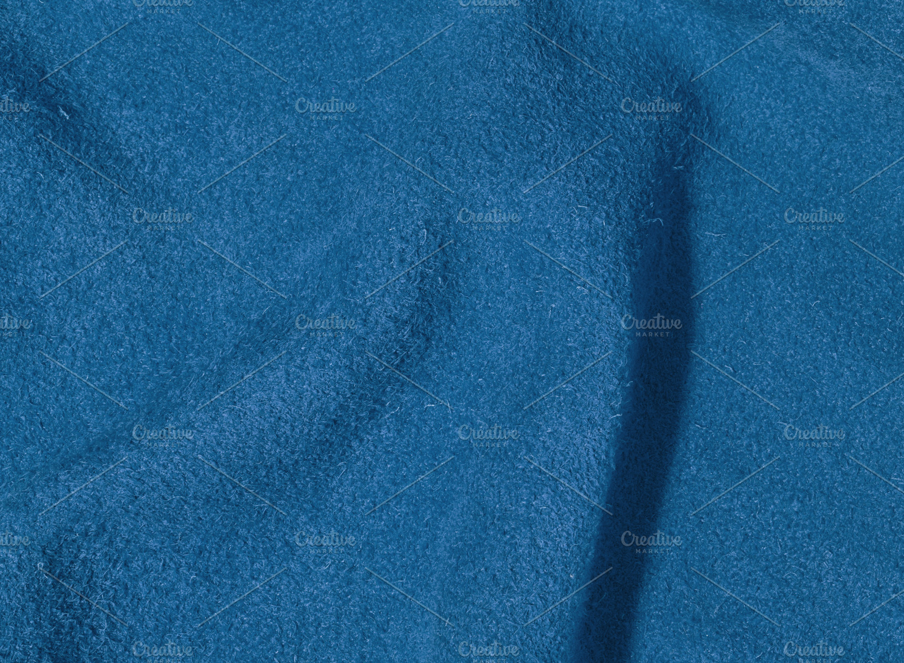 Blue suede texture with creases, fabric for bags and shoes, a Background Photo by ndanko