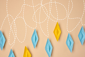 A creative composition featuring blue and yellow paper boats wit, a Business Photo by ndanko