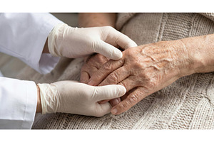 Senior Man Receives Hand Care, a Health & Medical Photo by CREATIVEDEF