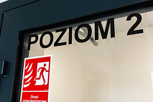 Door with Level 2 sign and red fire exit sticker for safety and emergency use, a Photo by AS photostudio