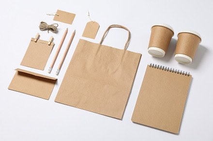 Composition with blank stationery, paper cups and bag on white b, a Business Photo by AtlasStudio