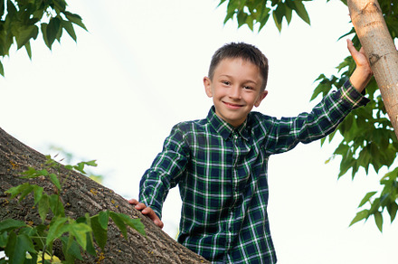 Boy relaxing on tree branch, a Person Photo by Elena Vagengeim