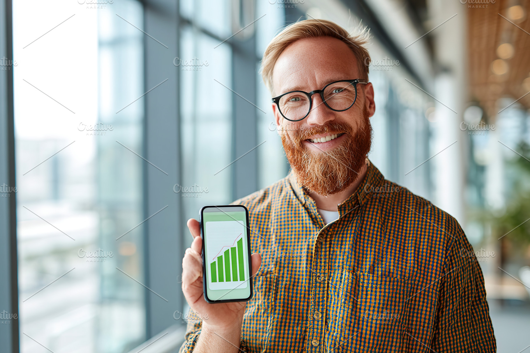 Young businessman showcasing growth statistics on smartphone in a modern office, a Business Photo by AlyaAnd