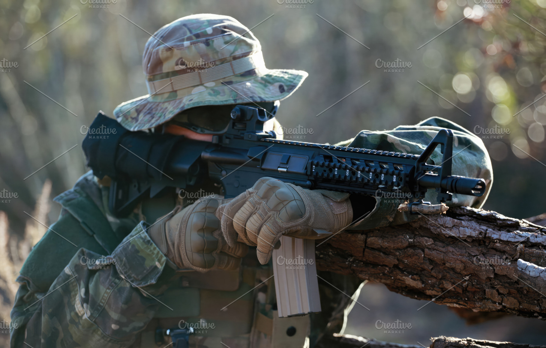 Soldier aiming with assault rifle during airsoft game in forest, a Sports & Recreation Photo by Antonio Gravante Market