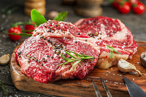 Raw beef steaks with herbs, a Food & Drink Photo by Volff