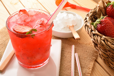 Glass of strawberry juice with ice on wooden table detail, a Food & Drink Photo by Davizro's Market