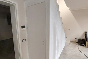 White flush to wall door under staircase during renovation, an Architecture Photo by Antonio Gravante Market