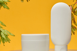 Cosmetic products without labels tube, flat round jar, stand on, a Beauty & Fashion Photo by ndanko