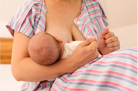 The mom is breastfeeding her newborn, a Health & Medical Photo by oksix