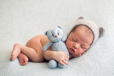 Newborn boy in a naked hat lies stock photo containing baby and newborn, a Person Photo by SaulichPhoto