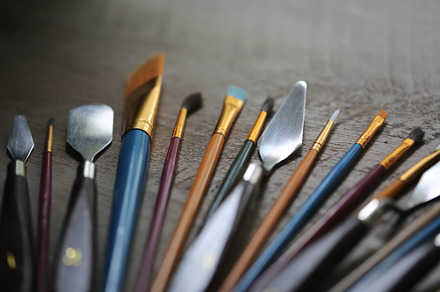 Paint Brushes on Rustic Table