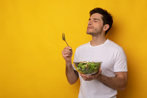 Portrait of Smiling Guy Holding Bowl With Salad