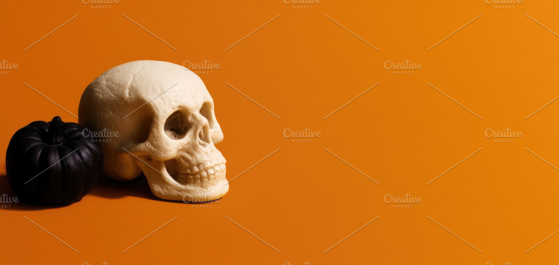 Halloween skull and black pumpkin on orange background, a Person Photo by José Manuel Gelpi