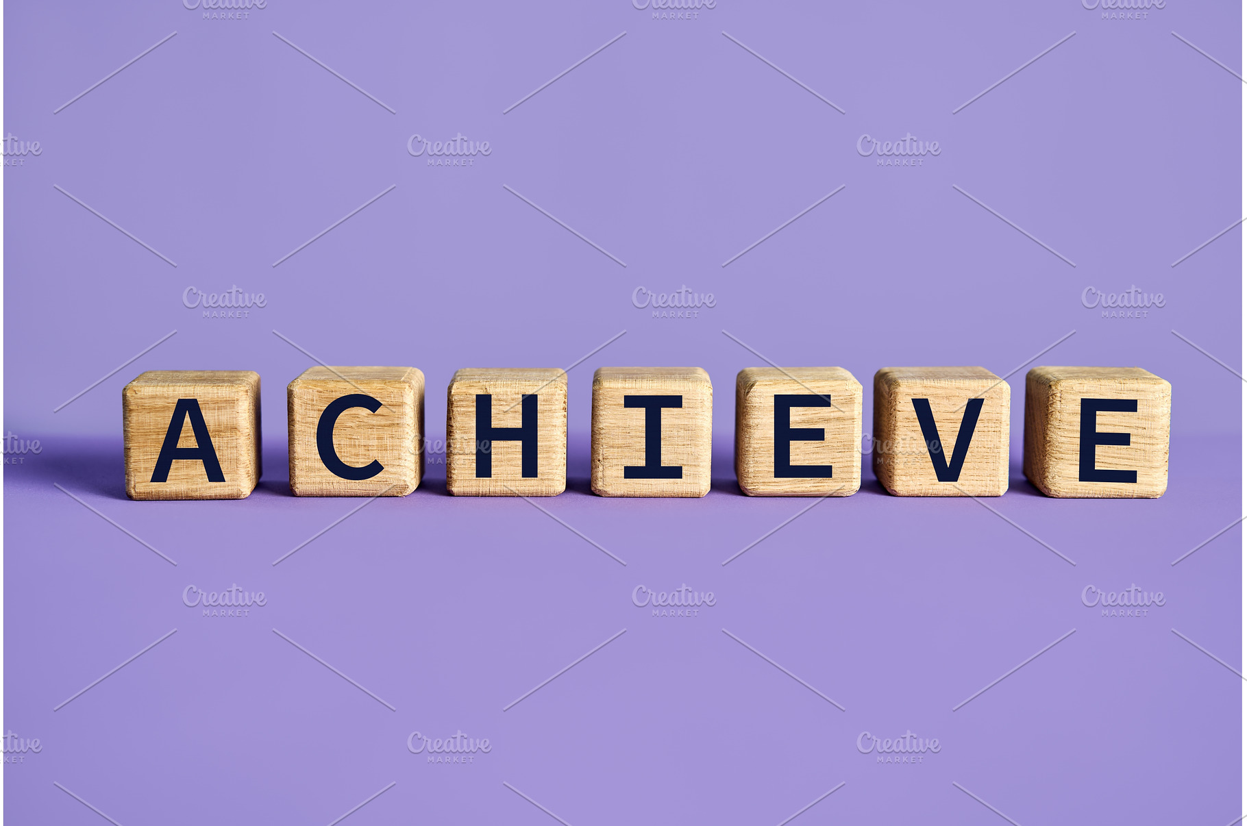 Achieve word on wooden cubes blocks, a Business Photo by Gladkov photography