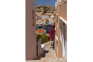 Symi harbor view through narrow, an Architecture Photo by kavalenkava