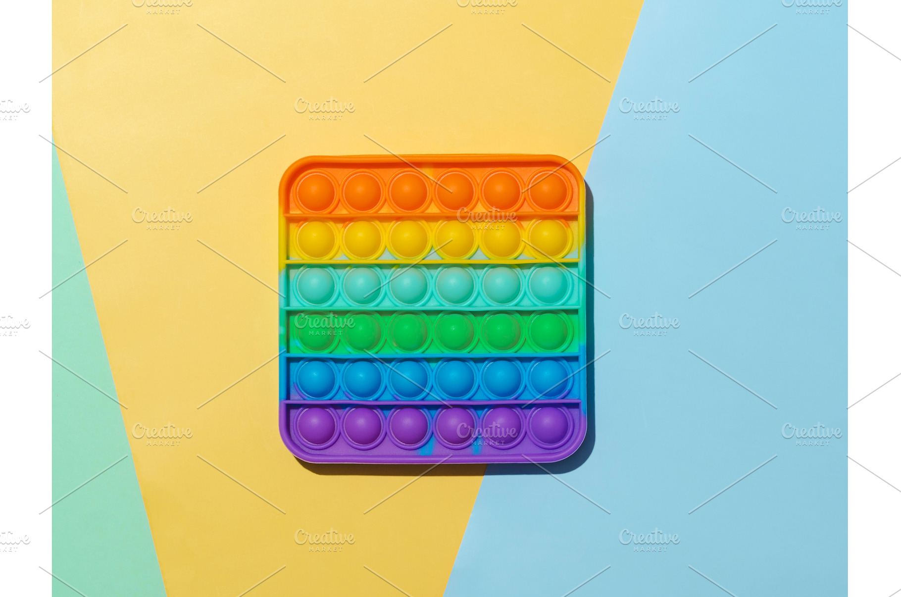Popit toy on multicolor background, a School & Education Photo by Fascinadora