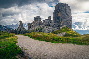Wide pebbly hiking trail in the Alps, a Nature Photo by Alpine Dreams