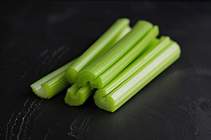 Green fresh celery sticks on black background, a Food & Drink Photo by AlyaAnd