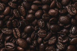 Roasted coffee beans filling a woven basket, creating an invitin, a Photo by Studio ANNA