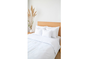 Minimalist bedroom with white linen, a Background Photo by Lermont51
