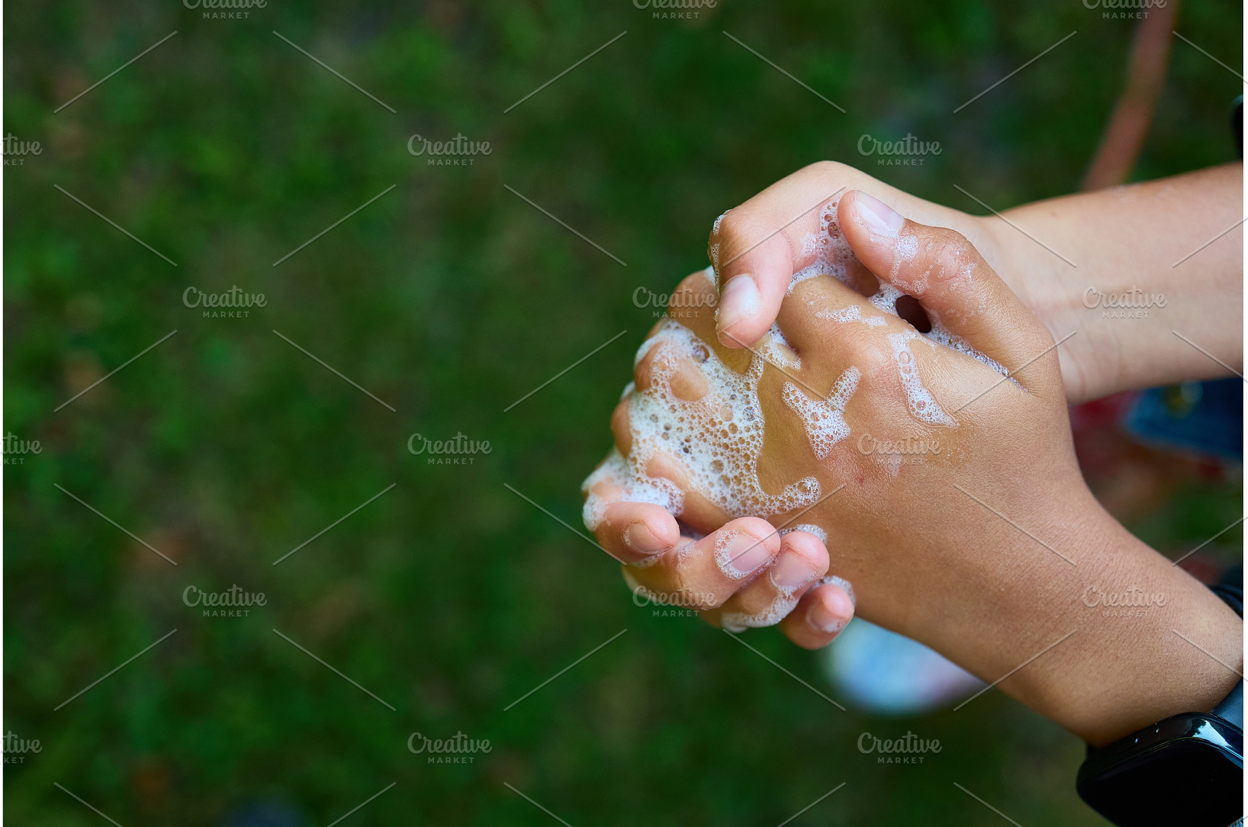 Washing hands with soap outdoors to, a Nature Photo by IlliaBondarPhotography