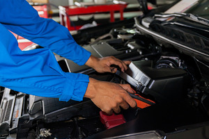 Mechanic fixing a broken car