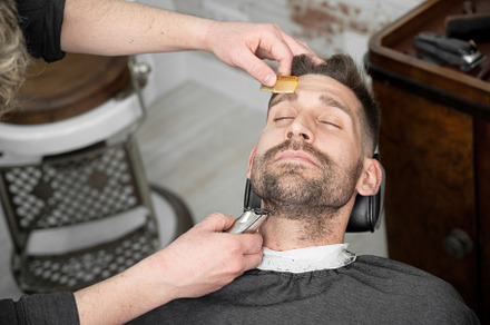 Young hipster Caucasian man during beard grooming in modern barber shop. Men's, a Person Photo by david.herraez.calzad