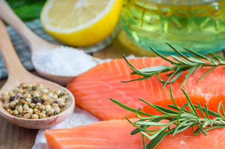 Fresh raw salmon fillet with rosemary and lemon, a Food & Drink Photo by iuliia_n