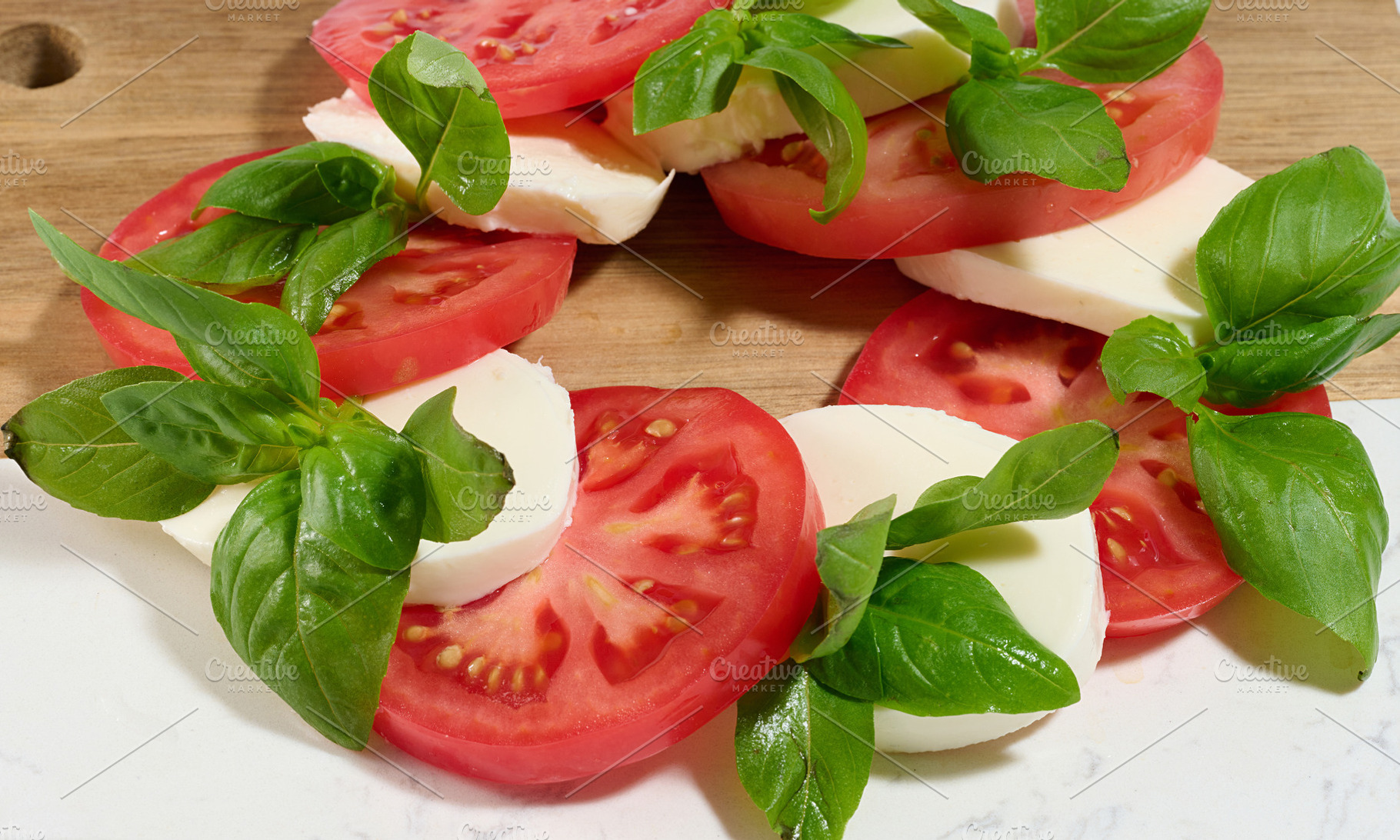 A close-up of a classic Caprese salad consisting of sliced, a Food & Drink Photo by ndanko