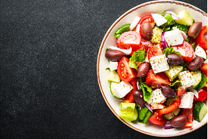 Greek salad in craft plate on black, a Food & Drink Photo by Nadia-nb