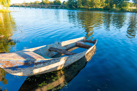 Wooden old fishing boat on river, a Nature Photo by Vapi