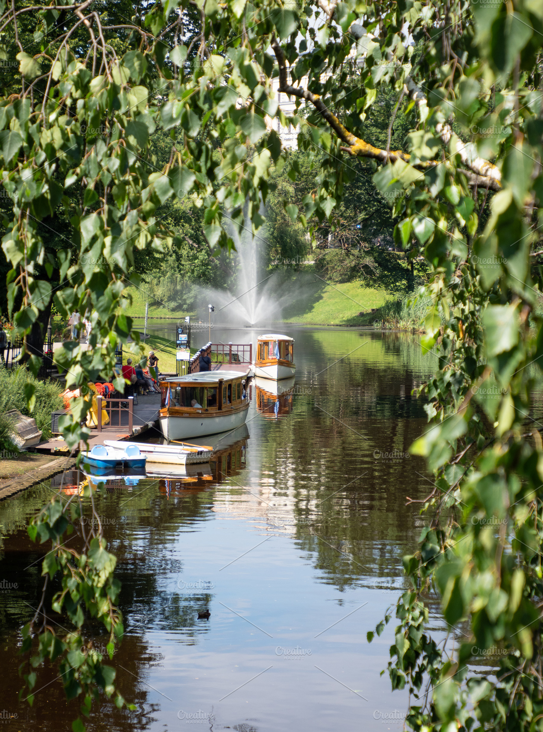 Wooden boat on canal in Riga, Latvia, a Photo by Annakaroline