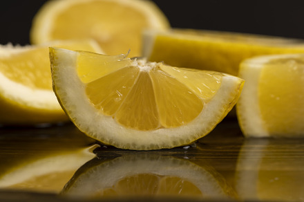 ripe sliced lemon on a board, a Photo by MyPhotos
