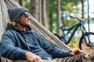 Man relaxing in a hammock in hoodie, a Person Photo by MistyDay