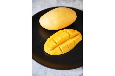 Fresh yellow mango fruit in a black, a Food & Drink Photo by Jan Jack Russo Media