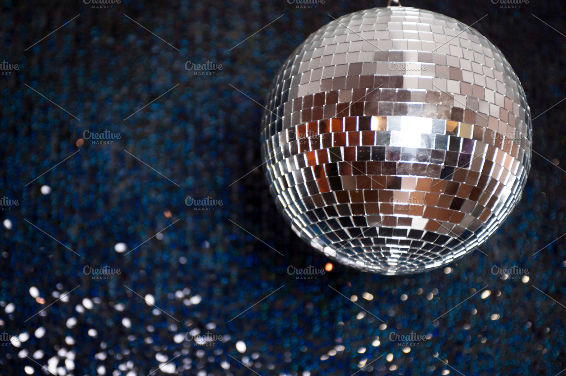 Mirror disco ball hanging from the ceiling containing disco, ball, and mirror, a Holiday Photo by MarinaMassel