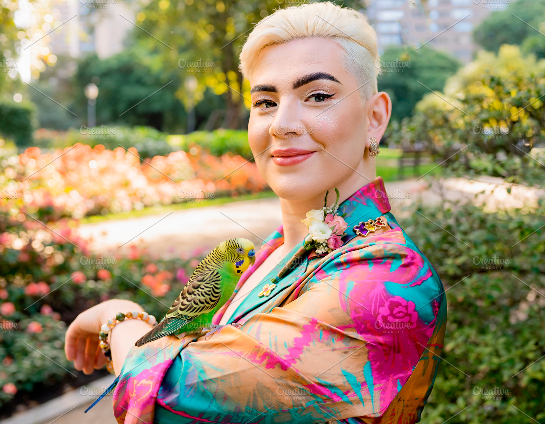Trans woman with budgerigar at urban park, a Person Photo by DanFLCreativo