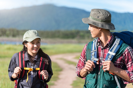 Two people walking on path in meadow field. Male and female trav, a Person Photo by Ministocker