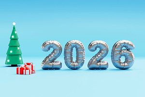 Shiny 2026 balloon digits with tree and gifts on blue studio, a Background Photo by RF Images